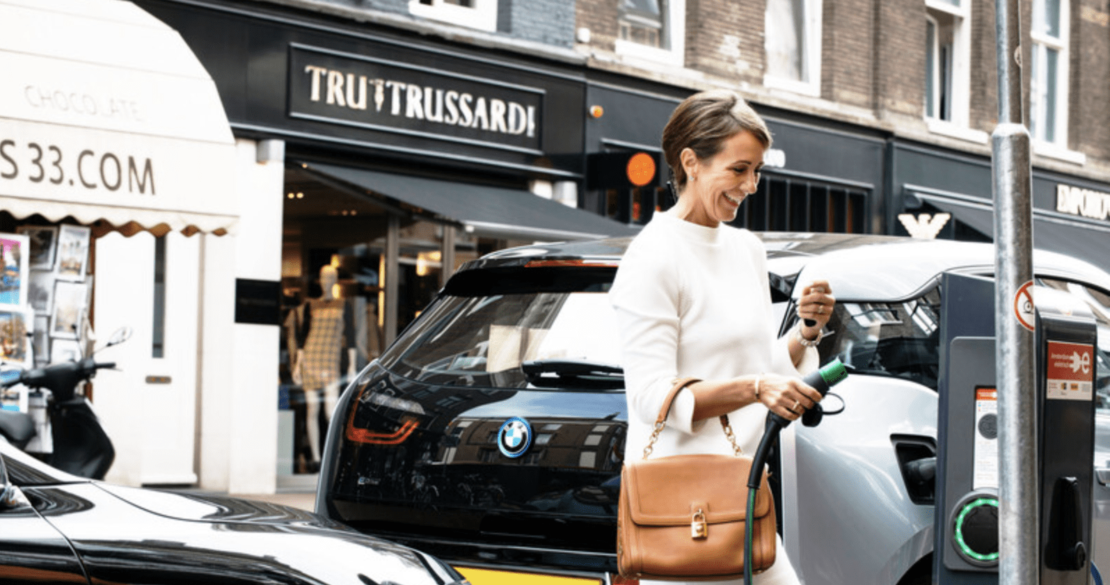 Woman using public charging station.