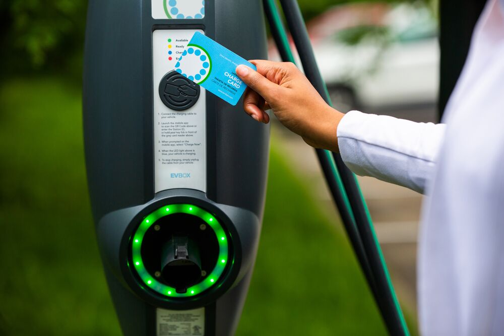 Person using charge card on EVBox Business Line charging station.