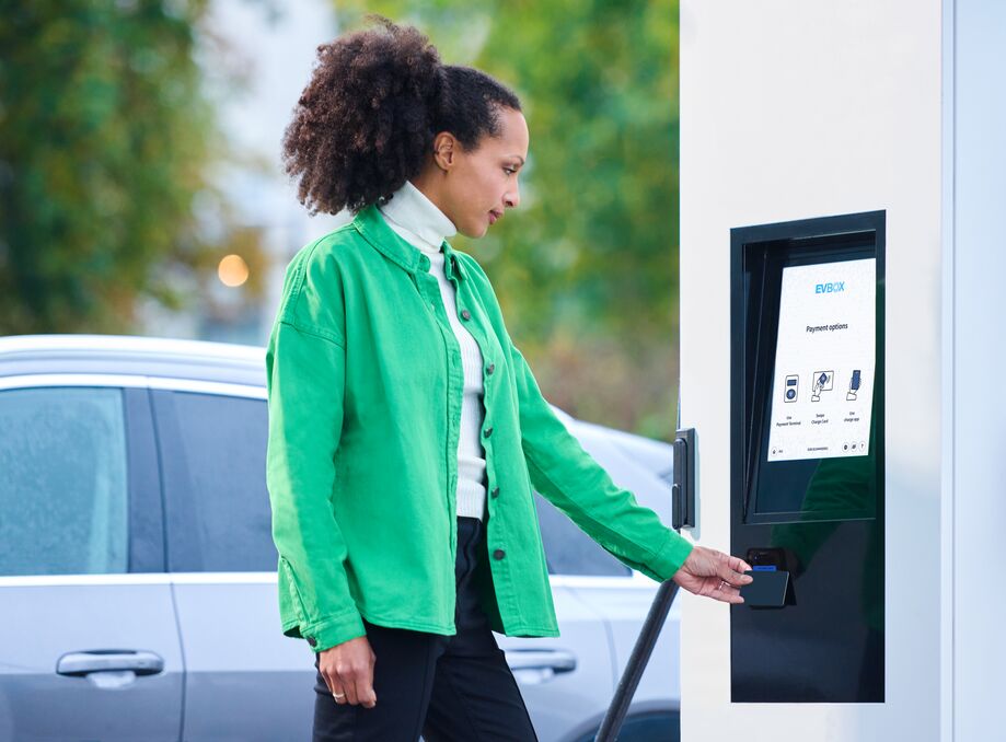 Woman using the fast charging EVBox Troniq Modular.