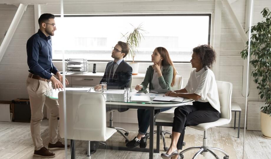 Employees in a modern corporate office having a meeting.