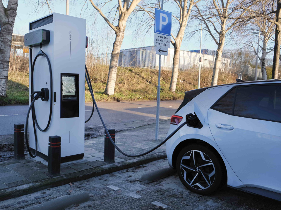 An EVBox Troniq Modular fast charging station charging a white EV