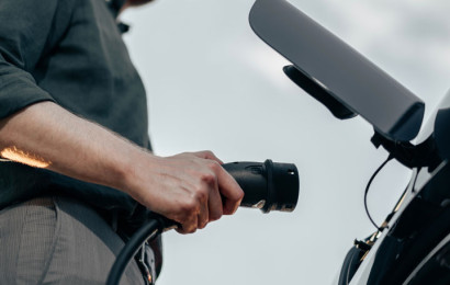 Modern person about to charge an electric car