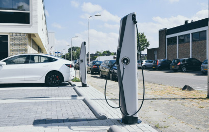 A corporate office's parking lot with two EVBox Troniq EV charging stations.