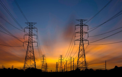 Two electrical towers at sunrise.