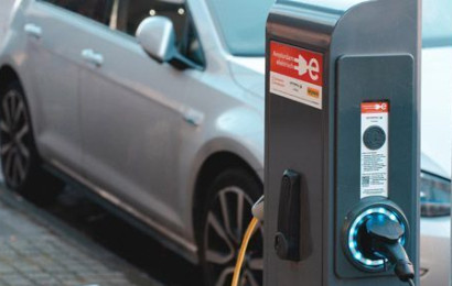 EVBox PublicLine charging station in front of an electric car