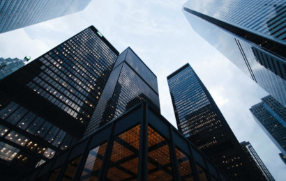 An impressive image of corporate skyscrapers reaching for the sky taken from the ground level.