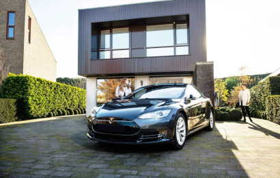 An electric vehicle parked in front of a house