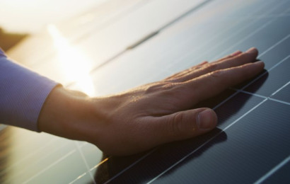 A hand on a solar panel